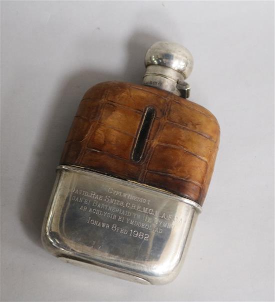 A George V silver mounted pocket flask, with engraved inscription, 14.3cm.